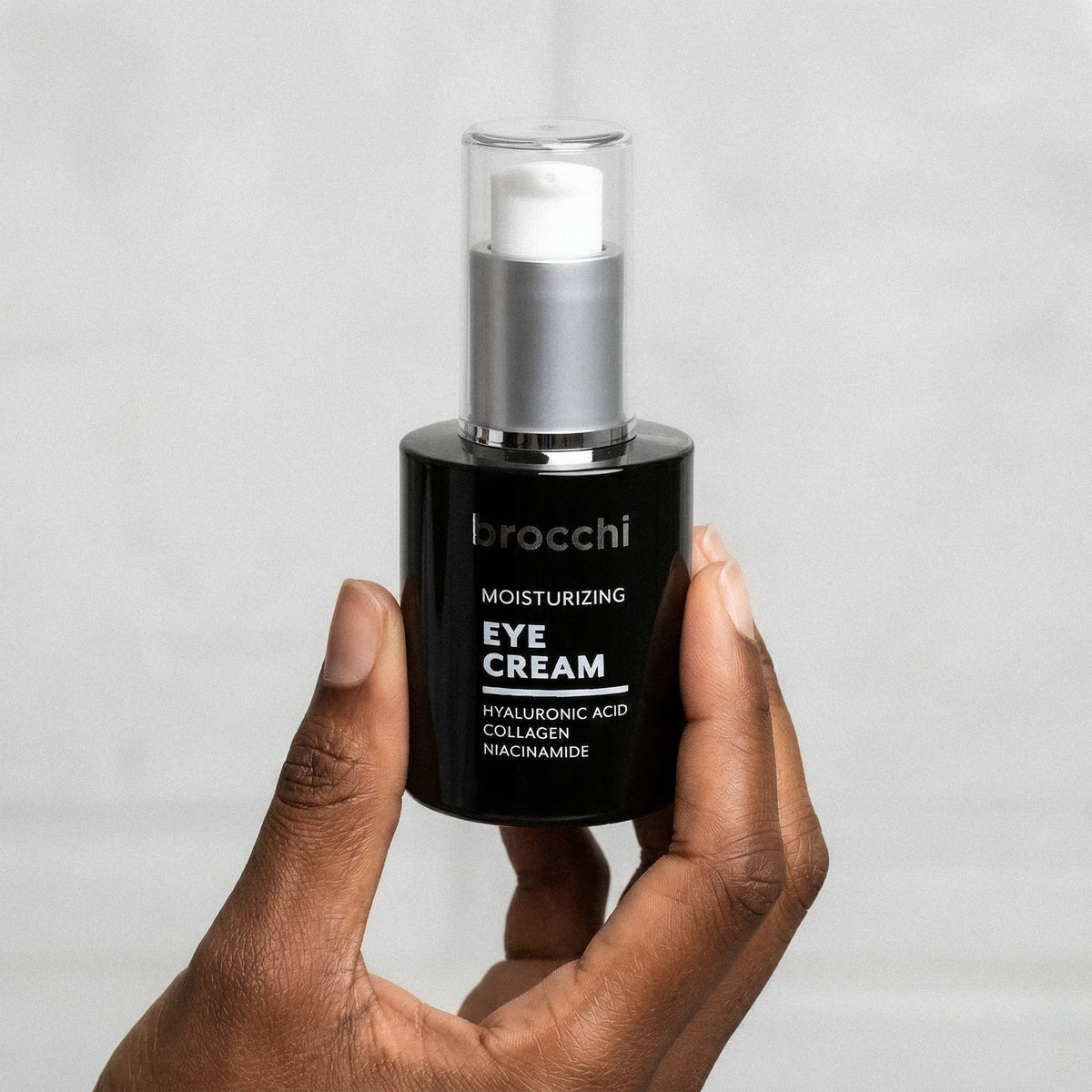 Hyaluronic Acid Eye Cream bottle held in hand