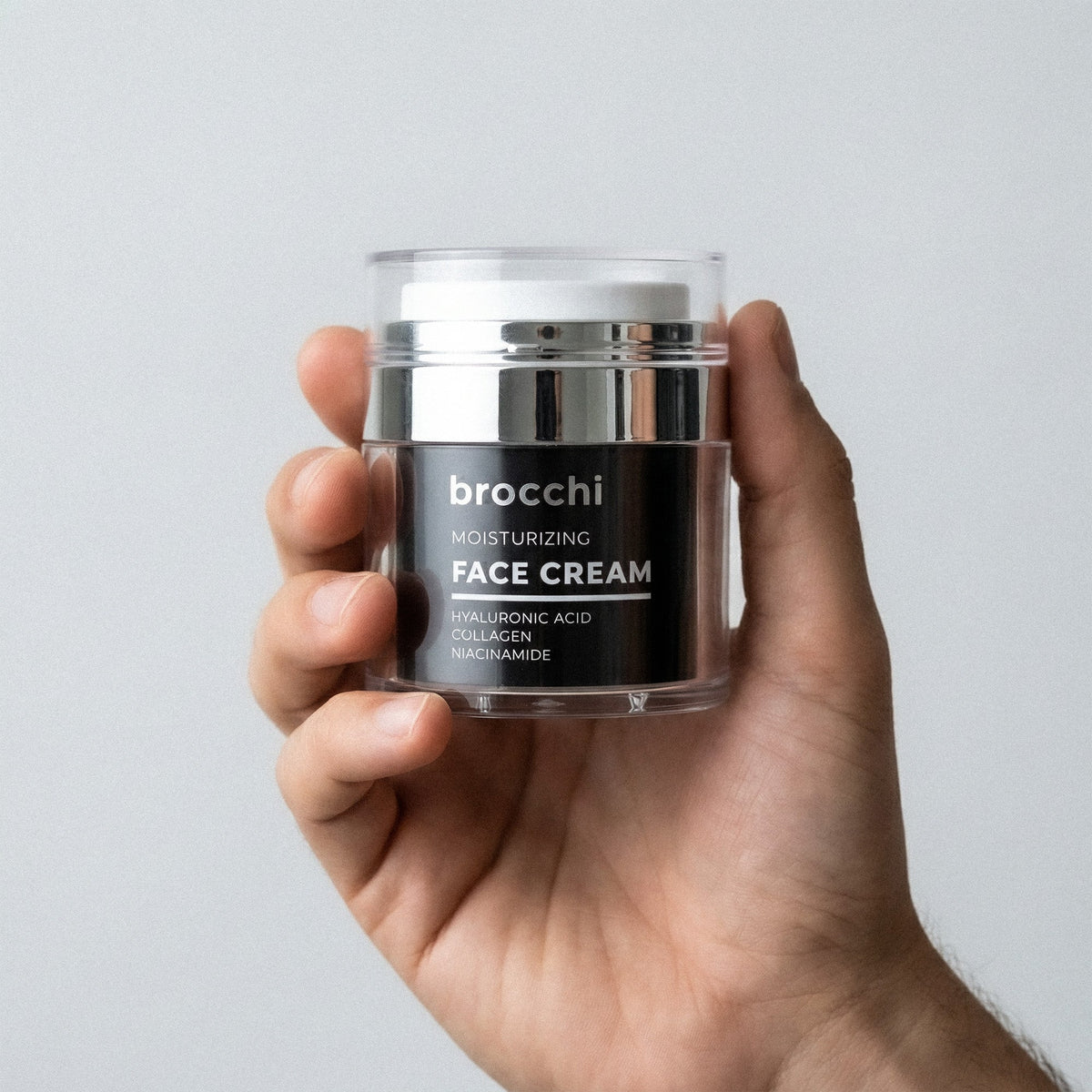 Hyaluronic Acid Face Cream jar held in hand