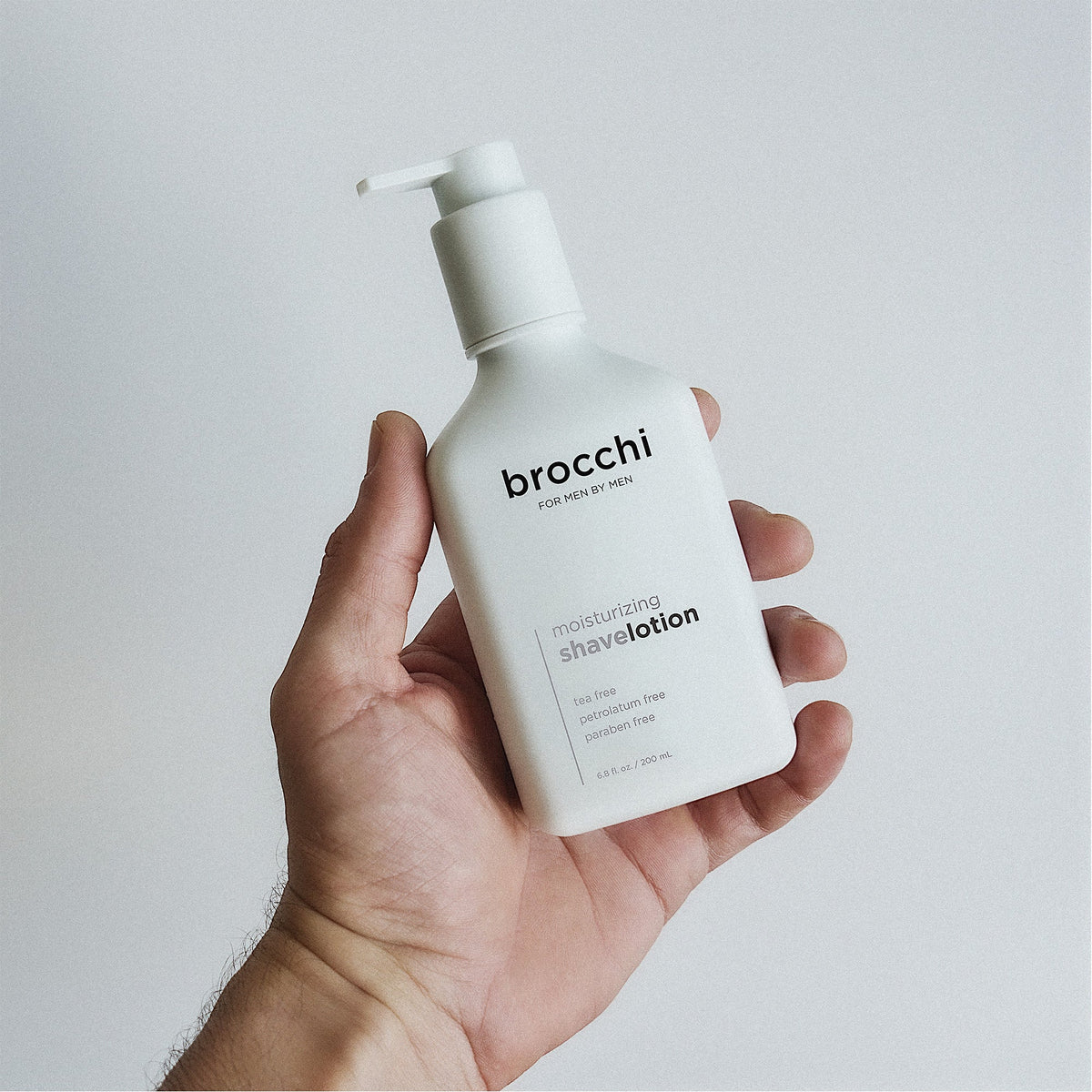 Moisturizing Shave Lotion bottle held in hand
