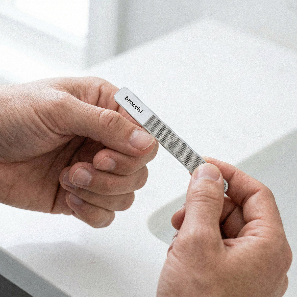 Smoothing a nail edge with the Nail Mastery file